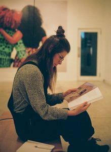 side profile photo of Jessica Johns reading a book